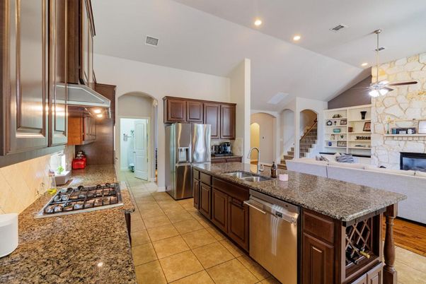 Fireplace, Interior, Kitchen, Pendant Lights, Recessed Lighting, Stainless Steel Appliances, Stone Walls