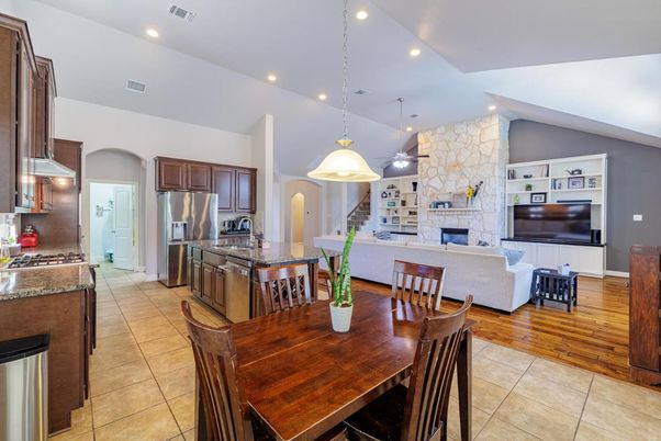 Dining room, Fireplace, Interior, Kitchen, Living room, Pendant Lights, Recessed Lighting, Stainless Steel Appliances, Stone Walls, Wood Texture Flooring
