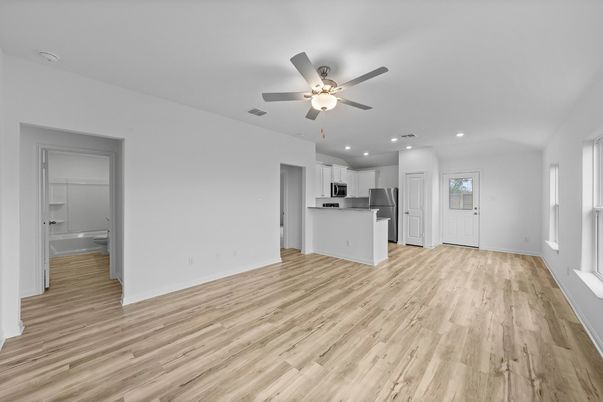 Empty room, Interior, Kitchen, Recessed Lighting, Stainless Steel Appliances, Wood Texture Flooring