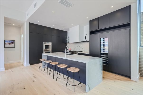 Interior, Kitchen, Marble Walls, Recessed Lighting, Stainless Steel Appliances, Wood Texture Flooring