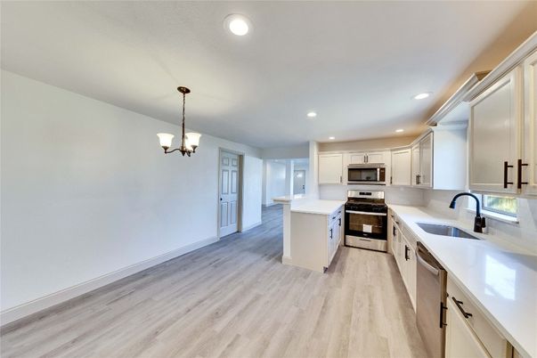 Chandelier, Interior, Kitchen, Pendant Lights, Recessed Lighting, Stainless Steel Appliances, Wood Texture Flooring