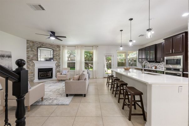 Fireplace, Interior, Kitchen, Living room, Pendant Lights, Recessed Lighting, Stainless Steel Appliances, Stone Walls