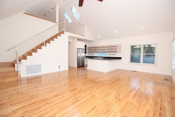 Empty room, Interior, Kitchen, Recessed Lighting, Stainless Steel Appliances, Wood Texture Flooring