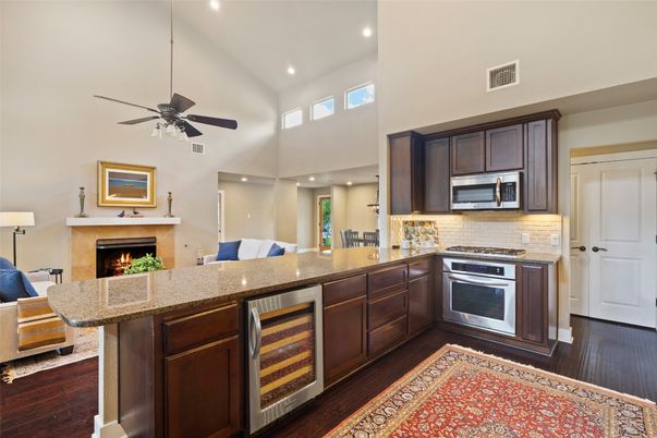 Fireplace, Interior, Kitchen, Recessed Lighting, Stainless Steel Appliances, Wood Texture Flooring