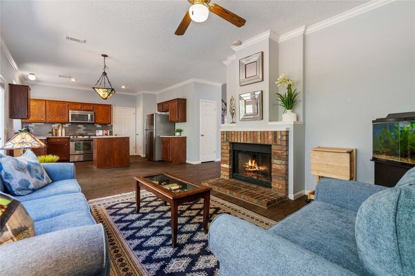 Fireplace, Interior, Kitchen, Living room, Pendant Lights, Recessed Lighting, Stainless Steel Appliances, Wood Texture Flooring