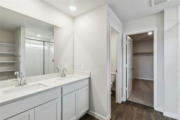 Bathroom, Dual Sink Vanities, Interior, Recessed Lighting, Walk-in Closets, Wood Texture Flooring