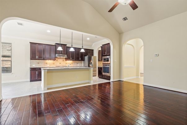 Empty room, Interior, Kitchen, Pendant Lights, Recessed Lighting, Stainless Steel Appliances, Wood Texture Flooring