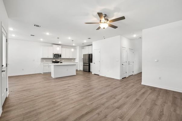 Empty room, Interior, Kitchen, Pendant Lights, Recessed Lighting, Stainless Steel Appliances, Wood Texture Flooring