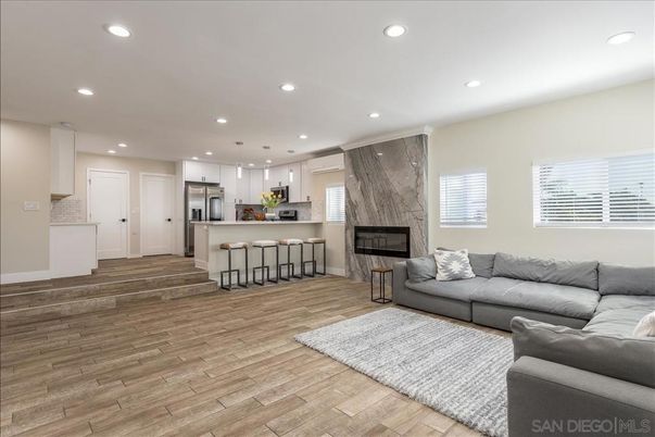 Fireplace, Interior, Kitchen, Living room, Pendant Lights, Recessed Lighting, Stainless Steel Appliances, Wood Texture Flooring