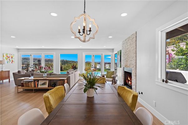 Dining room, Fireplace, Interior, Living room, Pendant Lights, Recessed Lighting, Stone Walls, Water, Wood Texture Flooring