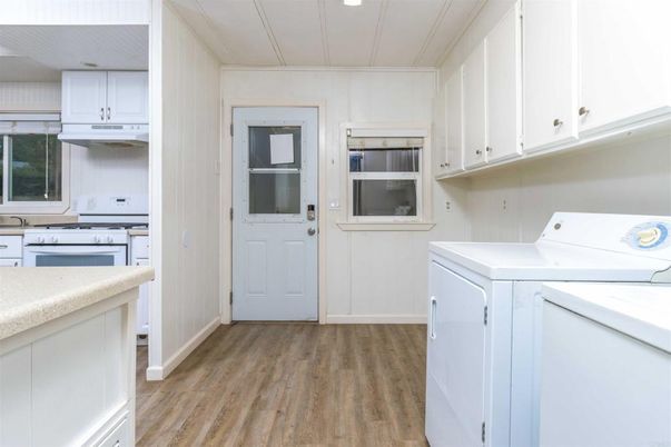 Interior, Kitchen, Recessed Lighting, Washer, Wood Texture Flooring