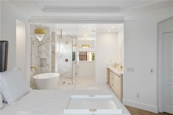 Bathroom, Chandelier, Dual Sink Vanities, Free Standing Baths, Interior, Marble, Marble Walls, Recessed Lighting, Wood Texture Flooring