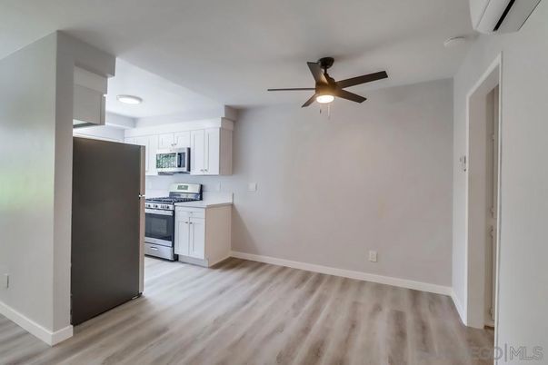 Empty room, Interior, Kitchen, Recessed Lighting, Stainless Steel Appliances, Wood Texture Flooring