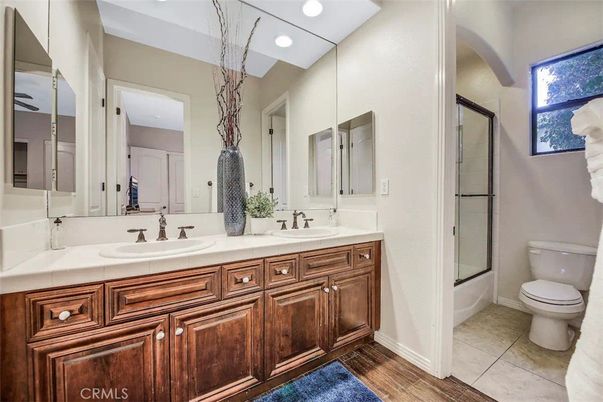Bathroom, Dual Sink Vanities, Glass Shower, Interior, Recessed Lighting, Tile Countertops, Wood Texture Flooring