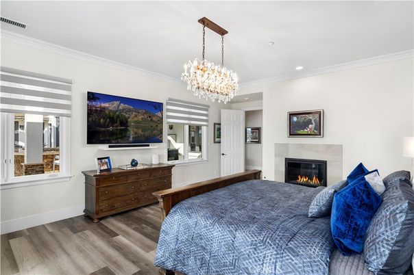 Bedroom, Chandelier, Fireplace, Interior, Recessed Lighting, Wood Texture Flooring