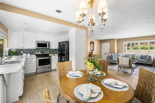 Chandelier, Dining room, Interior, Kitchen, Living room, Recessed Lighting, Stainless Steel Appliances, Wood Texture Flooring