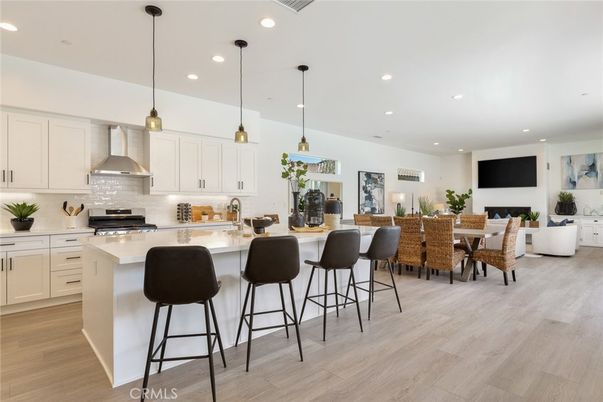 Dining room, Fireplace, Interior, Kitchen, Living room, Pendant Lights, Recessed Lighting, Stainless Steel Appliances, Wood Texture Flooring