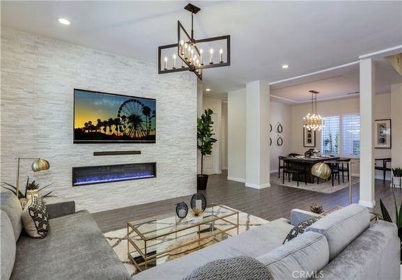 Chandelier, Dining room, Fireplace, Interior, Living room, Pendant Lights, Recessed Lighting, Stone Walls, Wood Texture Flooring