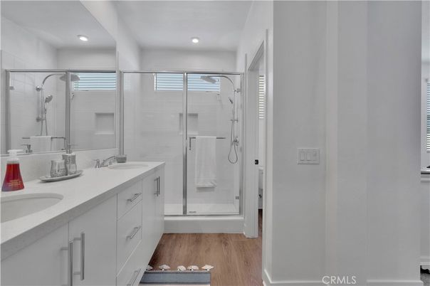 Bathroom, Dual Sink Vanities, Glass Shower, Interior, Recessed Lighting, Wood Texture Flooring