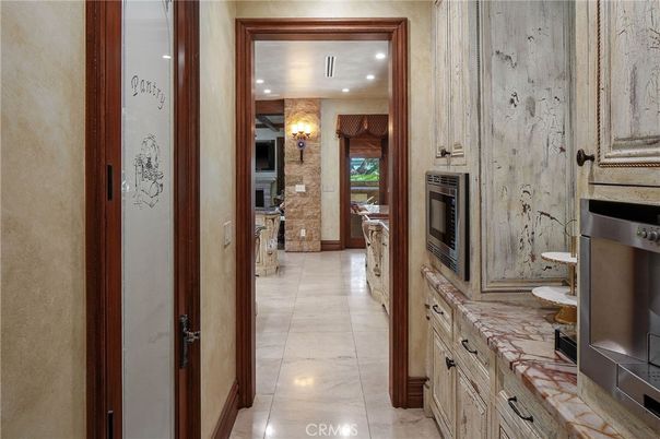 Fireplace, Interior, Kitchen, Recessed Lighting, Stainless Steel Appliances, Stone Walls