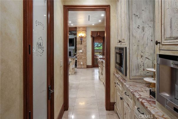 Fireplace, Interior, Kitchen, Recessed Lighting, Stainless Steel Appliances, Stone Walls