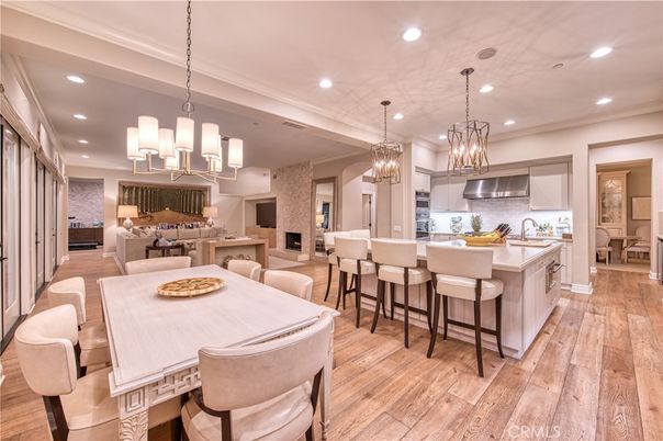 Chandelier, Dining room, Interior, Kitchen, Living room, Pendant Lights, Recessed Lighting, Stainless Steel Appliances, Wood Texture Flooring