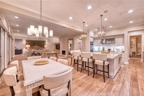 Chandelier, Dining room, Interior, Kitchen, Living room, Pendant Lights, Recessed Lighting, Stainless Steel Appliances, Wood Texture Flooring