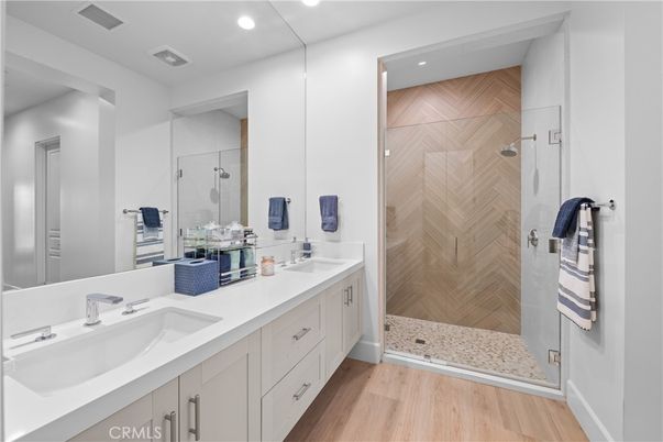 Bathroom, Dual Sink Vanities, Glass Shower, Interior, Recessed Lighting, Wood Texture Flooring