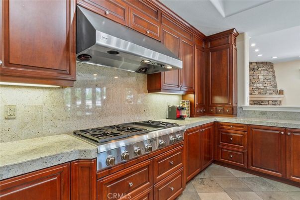 Fireplace, Interior, Kitchen, Recessed Lighting, Stainless Steel Appliances, Stone Walls