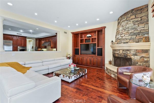 Fireplace, Interior, Kitchen, Living room, Recessed Lighting, Stainless Steel Appliances, Stone Walls, Wood Texture Flooring