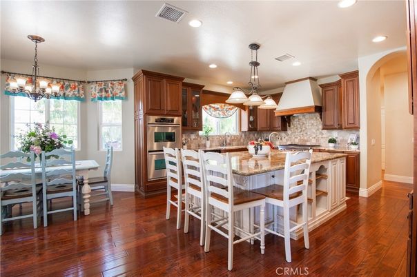Chandelier, Dining room, Interior, Kitchen, Pendant Lights, Recessed Lighting, Stainless Steel Appliances, Wood Texture Flooring