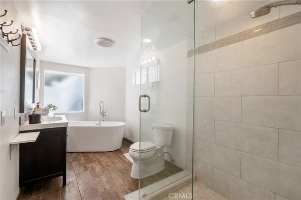 Bathroom, Free Standing Baths, Glass Shower, Interior, Recessed Lighting, Wood Texture Flooring