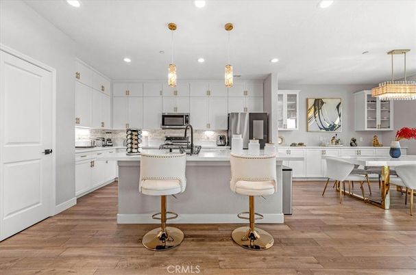 Dining room, Interior, Kitchen, Pendant Lights, Recessed Lighting, Stainless Steel Appliances, Wood Texture Flooring