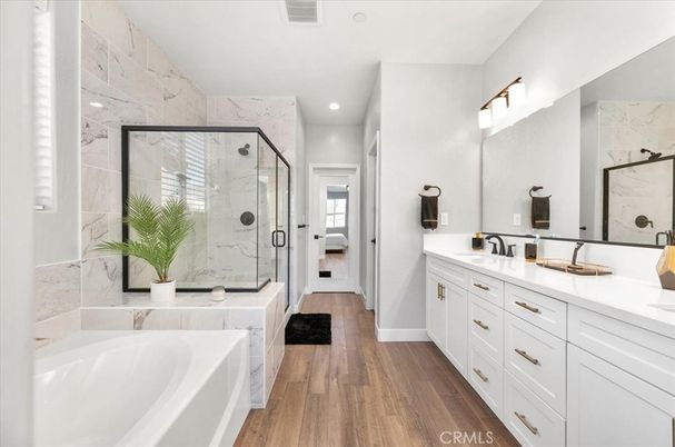 Bathroom, Dual Sink Vanities, Glass Shower, Interior, Marble Walls, Recessed Lighting, Wood Texture Flooring