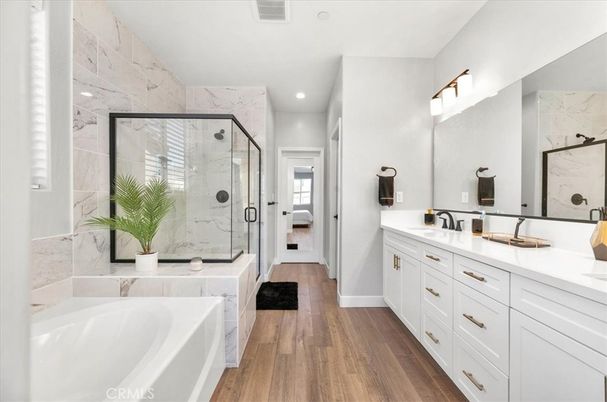Bathroom, Dual Sink Vanities, Glass Shower, Interior, Marble Walls, Recessed Lighting, Wood Texture Flooring