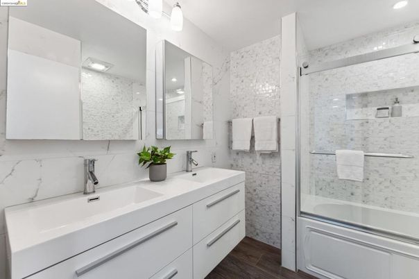 Bathroom, Dual Sink Vanities, Glass Shower, Interior, Marble Walls, Recessed Lighting, Wood Texture Flooring