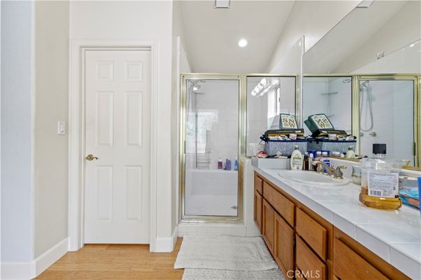 Bathroom, Dual Sink Vanities, Glass Shower, Interior, Recessed Lighting, Tile Countertops, Wood Texture Flooring