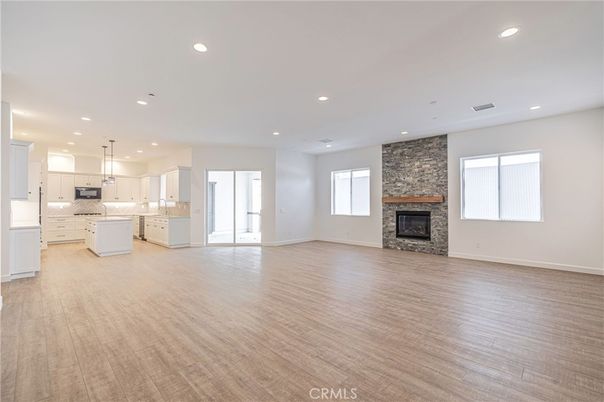Empty room, Fireplace, Interior, Kitchen, Pendant Lights, Recessed Lighting, Stone Walls, Wood Texture Flooring