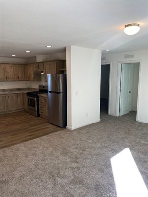 Empty room, Interior, Kitchen, Recessed Lighting, Stainless Steel Appliances, Wood Texture Flooring