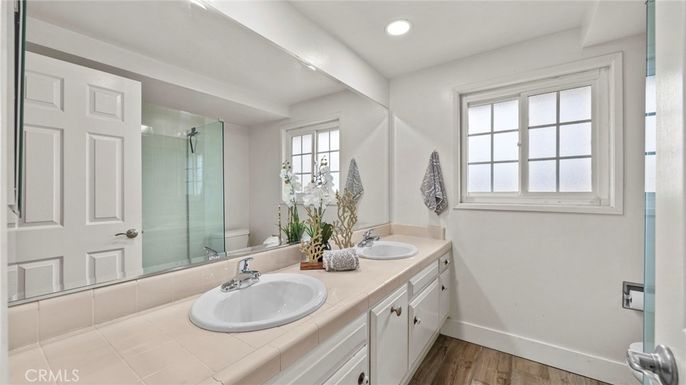 Bathroom, Dual Sink Vanities, Glass Shower, Interior, Recessed Lighting, Tile Countertops, Wood Texture Flooring
