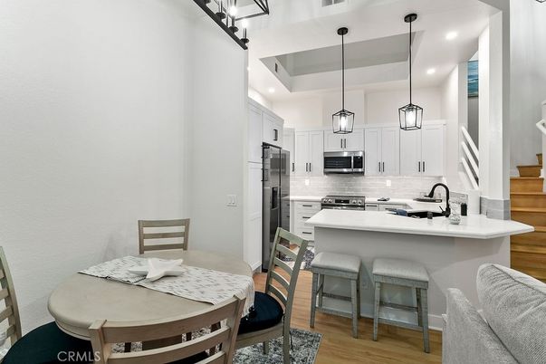 Dining room, Interior, Kitchen, Pendant Lights, Recessed Lighting, Stainless Steel Appliances, Wood Texture Flooring