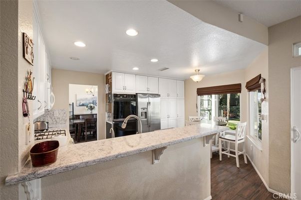 Interior, Kitchen, Recessed Lighting, Washer, Wood Texture Flooring