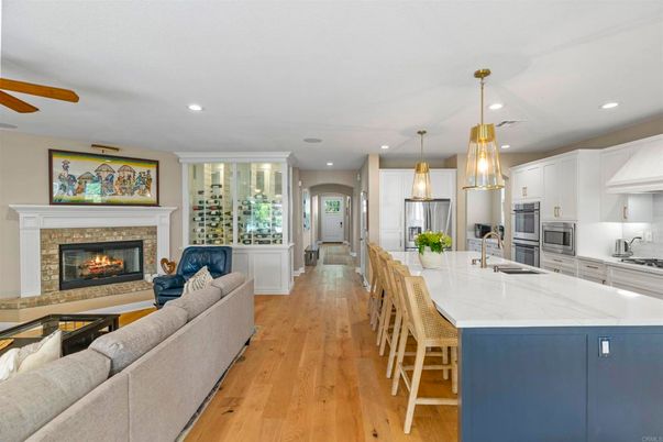Fireplace, Interior, Kitchen, Living room, Pendant Lights, Recessed Lighting, Stainless Steel Appliances, Wood Texture Flooring