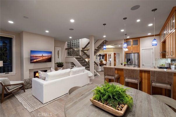 Fireplace, Interior, Kitchen, Living room, Pendant Lights, Recessed Lighting, Stainless Steel Appliances, Wood Texture Flooring