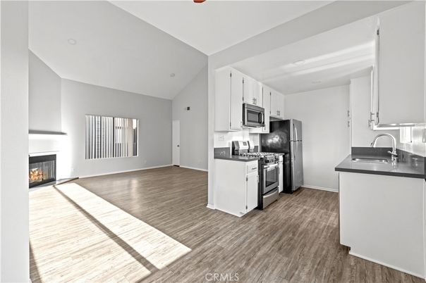 Fireplace, Interior, Kitchen, Recessed Lighting, Stainless Steel Appliances, Wood Texture Flooring
