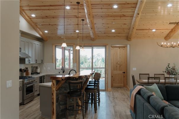 Chandelier, Dining room, Interior, Kitchen, Living room, Pendant Lights, Recessed Lighting, Stainless Steel Appliances, Wooden Beams, Wooden Ceilings, Wood Texture Flooring