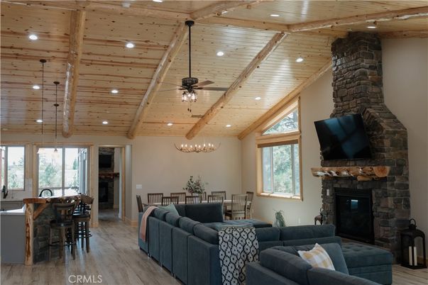 Chandelier, Dining room, Fireplace, Interior, Living room, Recessed Lighting, Stone Walls, Wooden Beams, Wooden Ceilings, Wood Texture Flooring