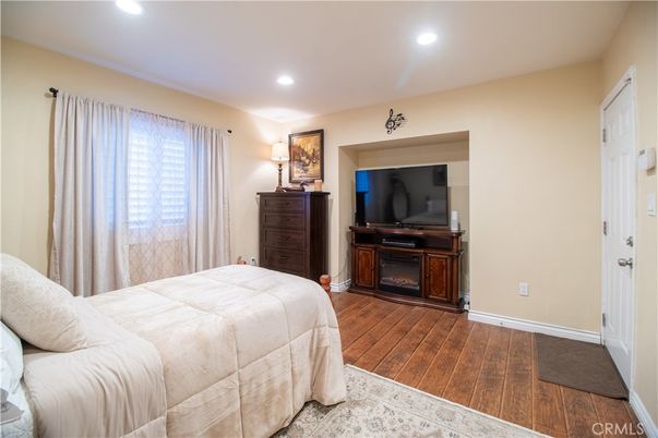 Bedroom, Fireplace, Interior, Recessed Lighting, Wood Texture Flooring