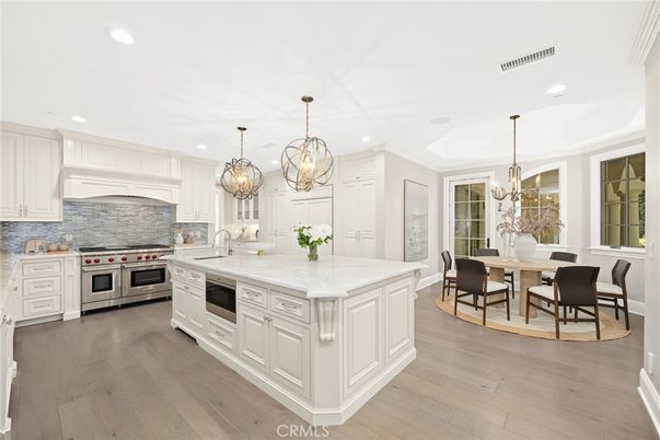 Chandelier, Dining room, Interior, Kitchen, Recessed Lighting, Stainless Steel Appliances, Wood Texture Flooring
