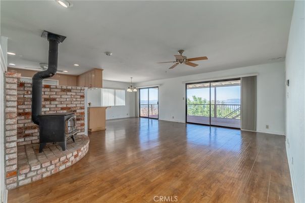 Empty room, Fireplace, Interior, Kitchen, Pendant Lights, Recessed Lighting, Stone Walls, Wood Texture Flooring